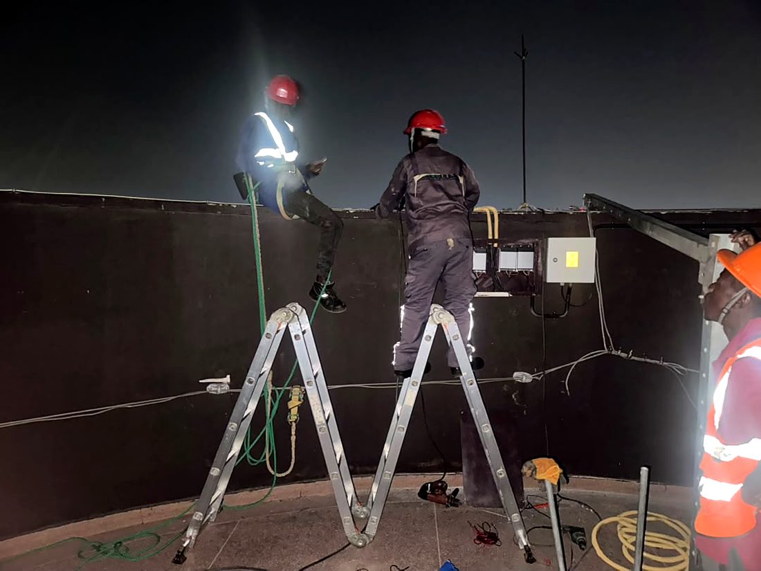 Rooftop signage — night lighting test before handover